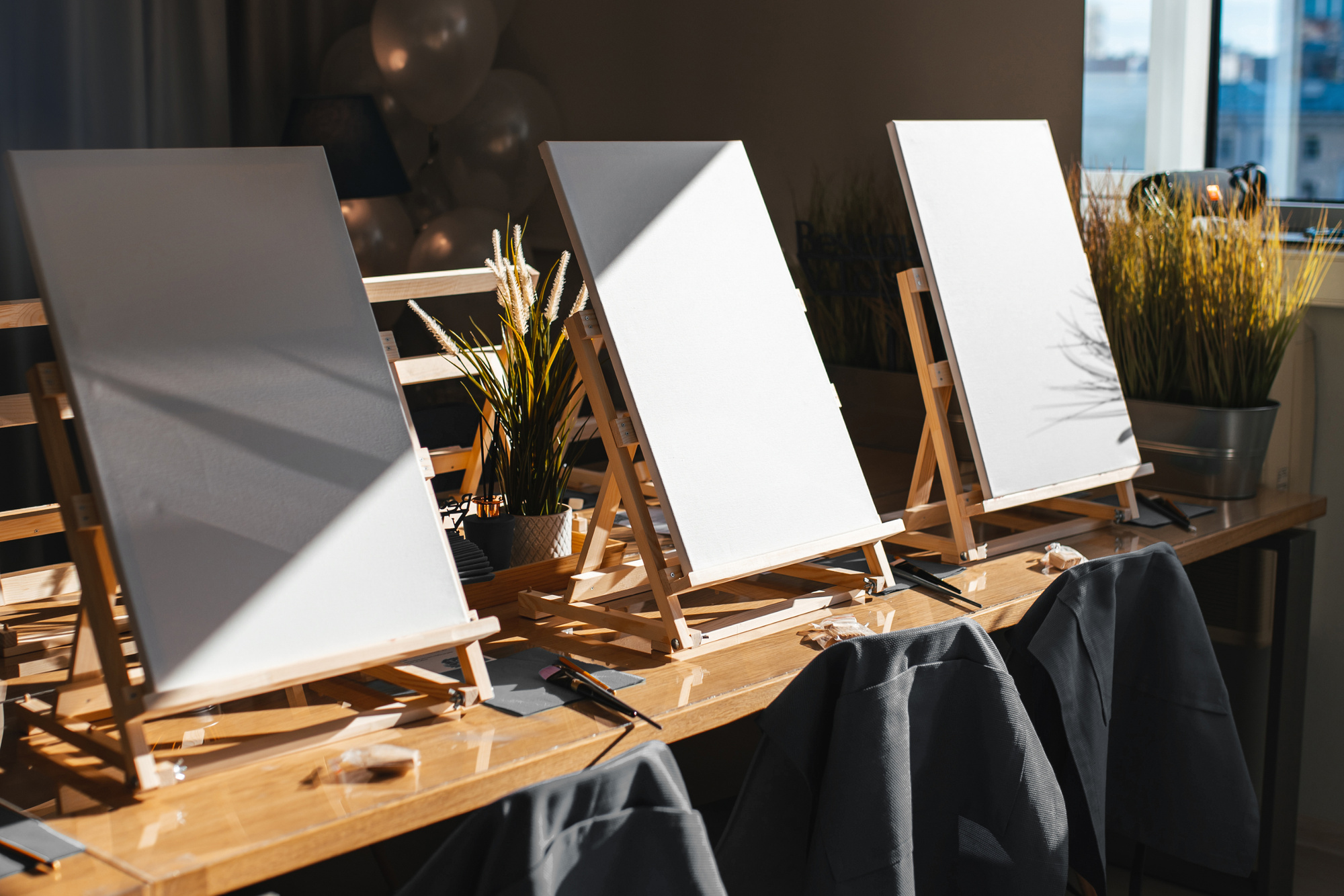 background with easels in art class.  Empty art class with easels and canvases  in the sun